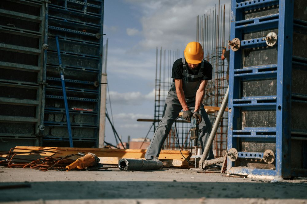Man in uniform is working on the construction site
